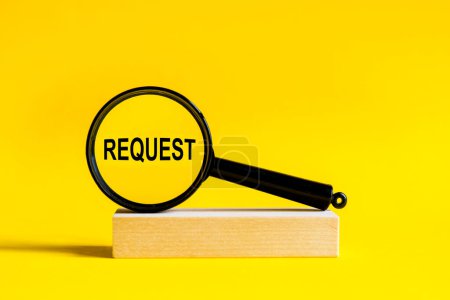 Photo for The inscription START through magnifying glass on yellow background. the magnifying glass is mounted on a wooden stand on a table - Royalty Free Image