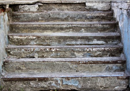 Old staircase destroyed rough grass on the steps 