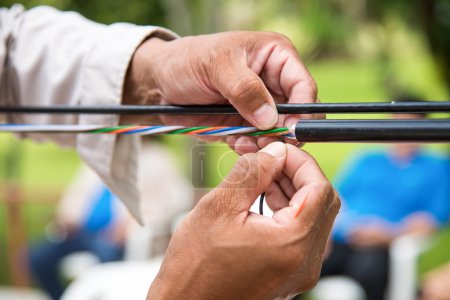 Photo for Technicians are installing optic fiber with cable ties. - Royalty Free Image