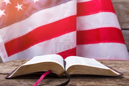 Photo for Opened book and USA flag. US flag behind a book. Education is power. You should know your rights. - Royalty Free Image