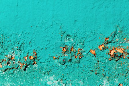 Photo for Old wall painted in bright turquoise color. Damaged and cracked paint texture. - Royalty Free Image