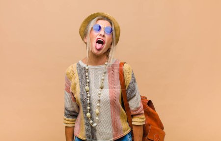 Photo for Middle age woman with cheerful, carefree, rebellious attitude, joking and sticking tongue out, having fun - Royalty Free Image