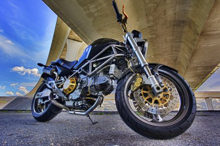 Photo for Modern cool motorbike on roadside stop under bridge - Royalty Free Image