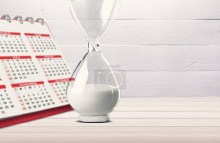 Reloj de arena retro y el concepto de calendario para el tiempo de deslizamiento lejos Reloj de arena retro y el concepto de calendario para el tiempo de deslizamiento lejos
