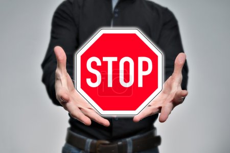 Photo for Man holding a virtual traffic sign in the hands - Royalty Free Image