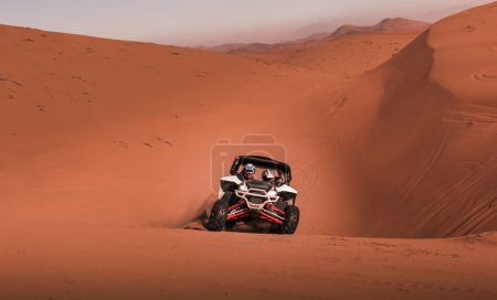 Photo for Buggy  in competition, crossing dunes in the desert - Royalty Free Image