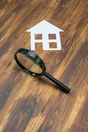 paper house with Magnifying Glass, House hunting