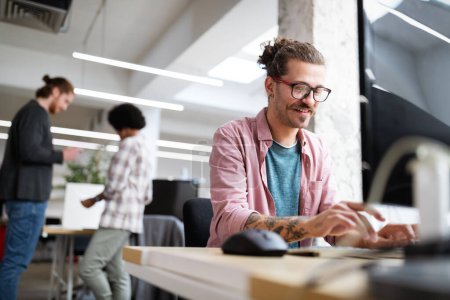 Photo for Programmer working and developing software in office on computer - Royalty Free Image