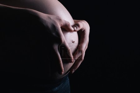 Photo for Heart sign made on a expectant belly - Royalty Free Image