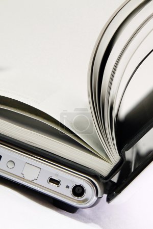 Photo for Open book over a laptop - Royalty Free Image