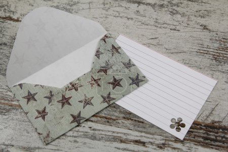 Photo for Handmade envelope and blank letter, in a paper with stars - Royalty Free Image