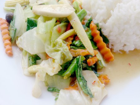 Photo for Vegetarian stir fry with thai jasmine rice on white dish, healthy food - Royalty Free Image