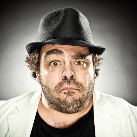 smiling fat beard man with hat portrait on grey background