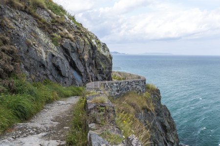 Photo for Stone rocks mountain hiking path at Irish seacoast. Bray, Greystone - Royalty Free Image