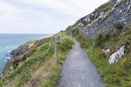 Photo for Stone rocks mountain hiking path at Irish seacoast. Bray, Greystone - Royalty Free Image