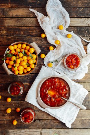 plums jam in a small cup. Homemade spicy mirabelle, greengage pl