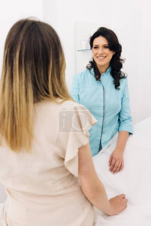 Family therapist female general practitioner worker during patient visit talking about upcoming treatment, test results. Health check up, medical insurance concept.