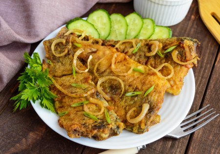 Photo for Fried carp fish fillet in batter on wooden table. Close-up - Royalty Free Image