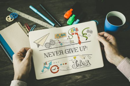 Photo for NEVER GIVE UP! sketch on notebook in businessman's hands - Royalty Free Image